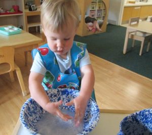 a peaceful reading corner in a Montessori classroom with children reading