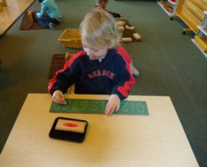 students participating in a cultural lesson with Montessori materials