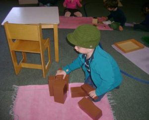 a shelf with Montessori educational materials promoting self-directed learning